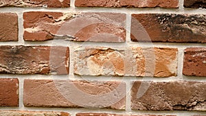 Rotation of red decorative brick with cracks. Brickwork background. Figure block