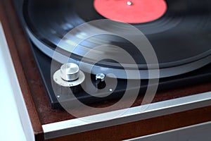 Rotation speed switch in old wintage turntable with instaled record side view closeup