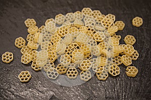 Rotelle Italian pasta from durum wheat on stone background, closeup