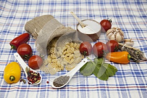 Rotelle Italian pasta set for the creation : cherry tomatoes, olive oil, balsamic sauce, garlic, spices, sea salt, salad on a rus