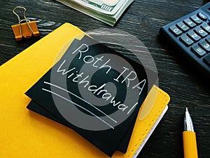 Roth IRA withdrawal words on a black page.