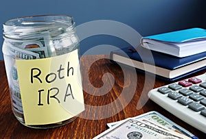 Roth ira written on a label of jar with money