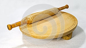 Roti or bread cutting and flatting board with rolling pin.