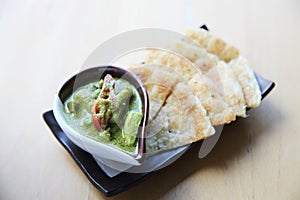 Roti with green curry on a plate