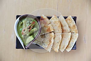 Roti with green curry on a plate