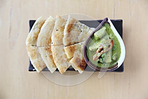 Roti with green curry on a plate