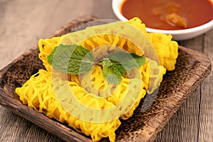 Roti Jala or Net Bread and curry dipping sauce