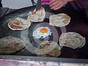 Roti Making, Roti and egg fried on the pan