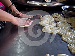 Roti Making, roti thresh flour by roti maker with oil. Indian traditional street food