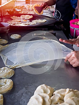 Roti Making, roti thresh flour by roti maker with oil. Indian traditional street food