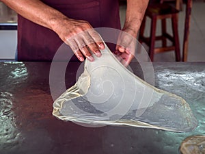 Roti Making, roti thresh flour by roti maker with oil. Indian traditional street food