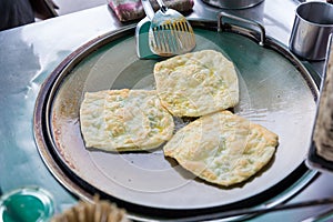 Roti Making, roti thresh flour by roti maker with oil. Indian traditional street food. Thai Pancake Banana And Egg .