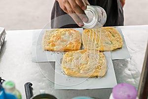 Roti Making, roti thresh flour by roti maker with oil. Indian traditional street food. Thai Pancake Banana And Egg .