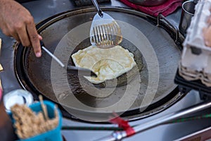Roti Making, roti thresh flour by roti maker with oil. Indian traditional street food. Thai Pancake Banana And Egg . Thai Street F