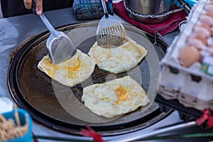 Roti Making, roti thresh flour by roti maker with oil. Indian traditional street food. Thai Pancake Banana And Egg . Thai Street F