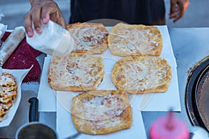 Roti Making, roti thresh flour by roti maker with oil. Indian traditional street food. Thai Pancake Banana And Egg . Thai Street F