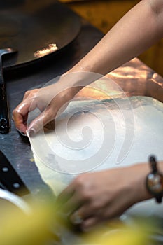 Roti Making, roti thresh flour by roti maker with oil.Thailand Street Food and Desserts. crispy pancake in Thailand