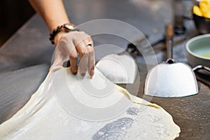 Roti Making, roti thresh flour by roti maker with oil.Thailand Street Food and Desserts. crispy pancake in Thailand