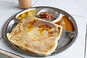Roti planta is popular breakfast in Malaysia. It is roti canai with added margarine. photo