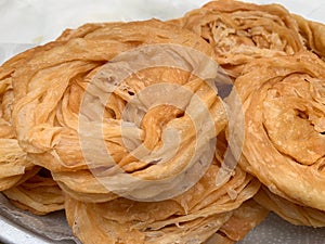 Roti plate, golden yellow circle picture frame on the blotting paper, Roti fried food group with trans fat