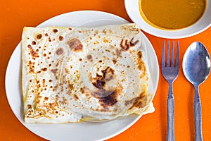 Roti Prata or Roti Canai, a traditional Indian bread served with curry