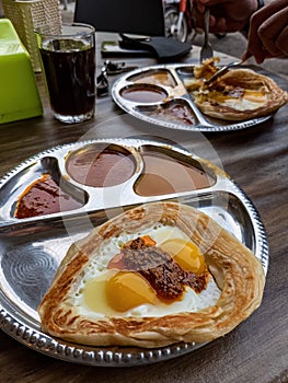 Roti sarang burung served with different gravies