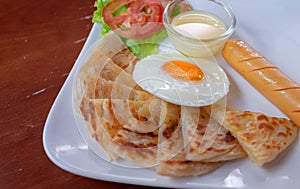 Roti with sweetened condensed milk and fried egg, golden delicious.