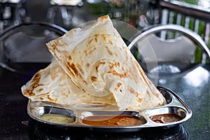 Roti Tisu or Tissue Bread is crunchy form of bread served at mamak restaurant in Malaysia