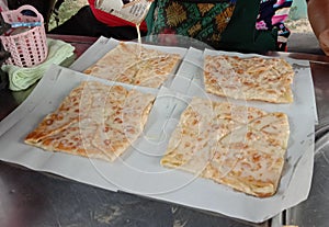 Roti is a type of food made from dough kneaded and then fried or grilled into thin strips.