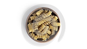 Rotini pasta in wooden bowl  on a white background.