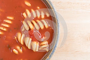 Rotini tomato soup in a bowl on table
