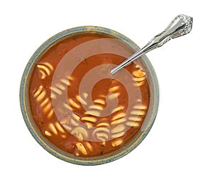 Rotini tomato soup in a bowl on a white background