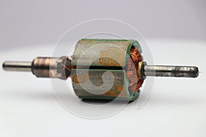 Rotor of a dc motor with rusty layer on the surface on white background