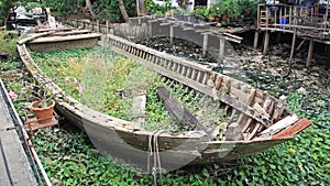 Rotted and abandoned row wooden boat