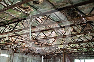 Rotted and corroded ceiling structure in abandoned shop