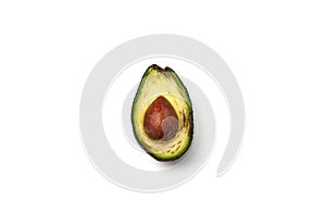 A rotten avocado cut in half on white background. Avocado is rotten and no longer good to eat