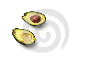 A rotten avocado cut in half on white background. Copy space