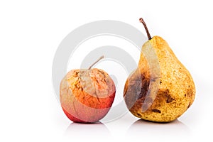 Rotten and decomposing red apple and pear on white background