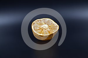 Rotten lime fruit on seen from above on a dark background