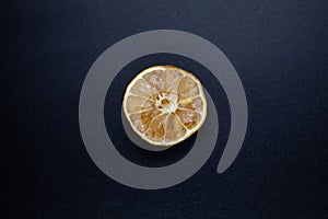 Rotten lime fruit on seen from above on a dark background