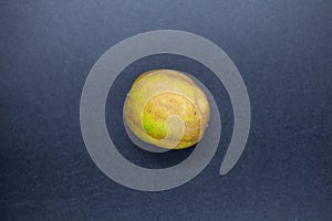 Rotten lime fruit on seen from above on a dark background