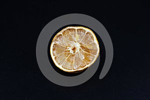 Rotten lime fruit on seen from above on a dark background