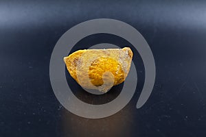 Rotten lime fruit on seen from above on a dark background