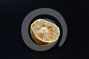 Rotten lime fruit on seen from above on a dark background photo