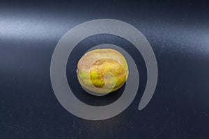 Rotten lime fruit on seen from above on a dark background photo