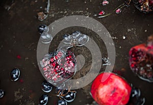 Rotten pomegranates and grapes