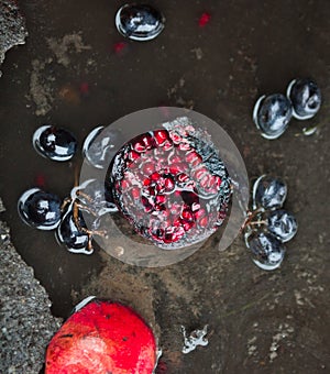 Rotten pomegranates and grapes