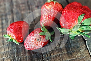 Rotten strawberries on a wooden background