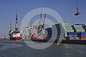 Rotterdam. Large harbor crane lifting a sea container