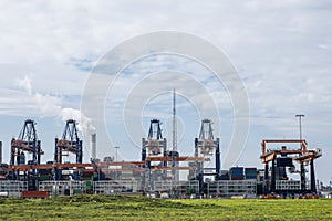 ROTTERDAM, THE NETHERLANDS Container being loaded by gantry cranes in the Maasvlakte in the Port of Rotterdam photo